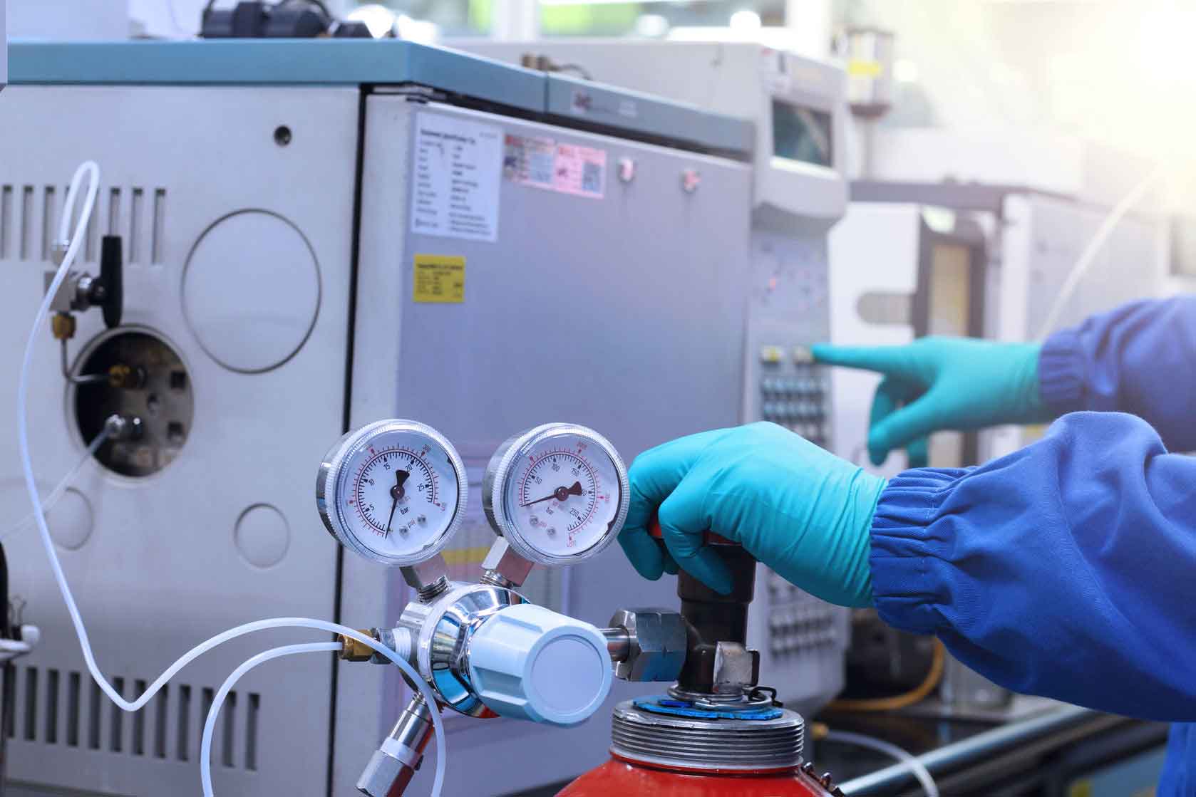 Laboratory technician operating analytical equipment